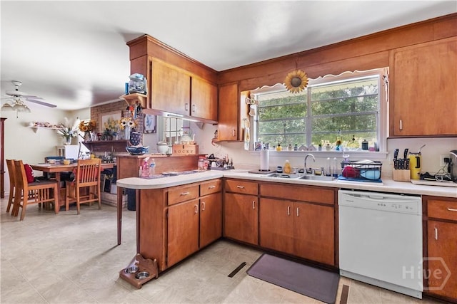 106 S Old Augusta Rd S, Rincon, GA 31326 - kitchen featuring white dishwasher, light countertops, brown cabinetry, and a peninsula