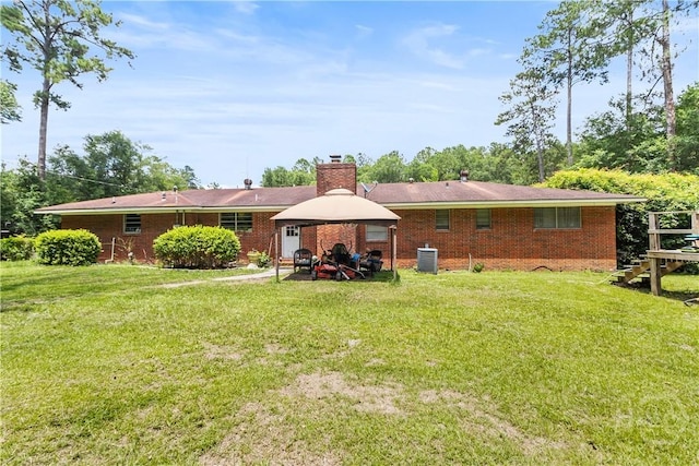 106 S Old Augusta Rd S, Rincon, GA 31326 - back of property with a gazebo, a yard, a chimney, and brick siding