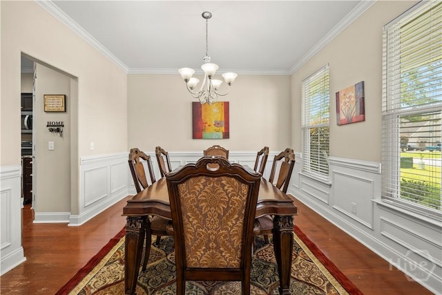 10 Broken Bit Rd, Ellabell, GA 31308 - dining area featuring dark wood-style flooring, ornamental molding, a chandelier, wainscoting, and a decorative wall
