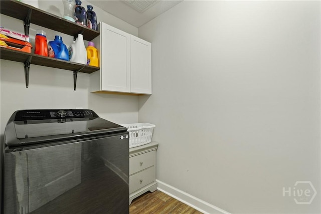 1175 Ralph Rahn Rd, Rincon, GA 31326 - laundry room featuring washer / clothes dryer, cabinet space, and wood finished floors