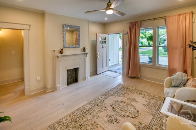 1136 E 39th St, Savannah, GA 31404 - living area with ceiling fan, a tiled fireplace, and light wood finished floors