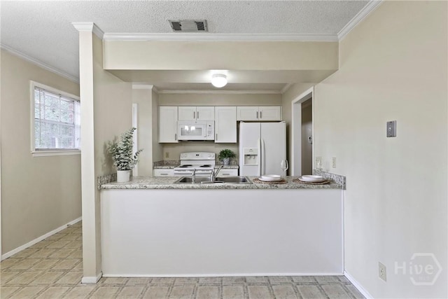 429 Edgewater Rd, Savannah, GA 31406 - kitchen featuring white appliances, a peninsula, crown molding, white cabinets, and a textured ceiling