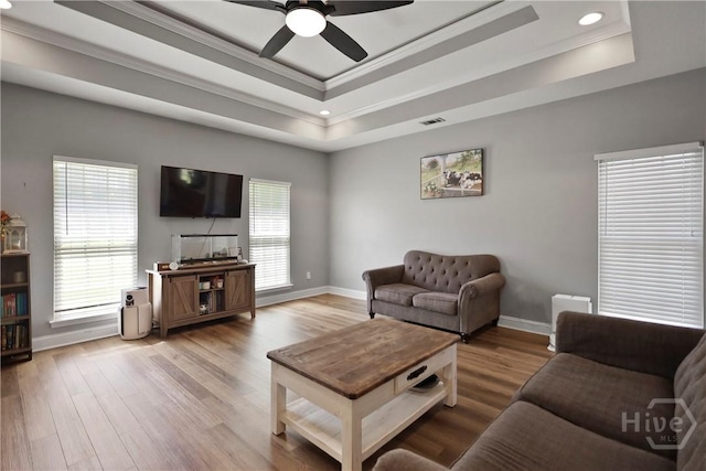 43 Gracie Ln NE, Ludowici, GA 31316 - living area featuring a tray ceiling, ceiling fan, wood finished floors, ornamental molding, and recessed lighting
