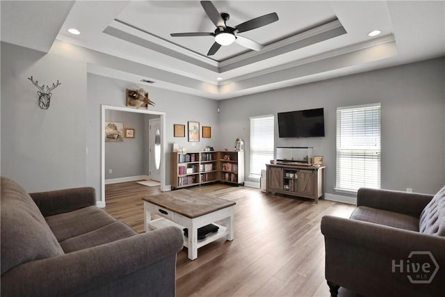 43 Gracie Ln NE, Ludowici, GA 31316 - living area featuring a raised ceiling, ornamental molding, a ceiling fan, recessed lighting, and wood finished floors