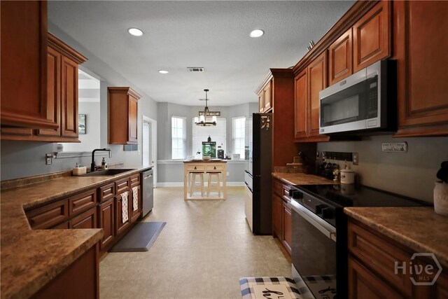 43 Gracie Ln NE, Ludowici, GA 31316 - kitchen featuring appliances with stainless steel finishes, a chandelier, recessed lighting, dark countertops, and pendant lighting