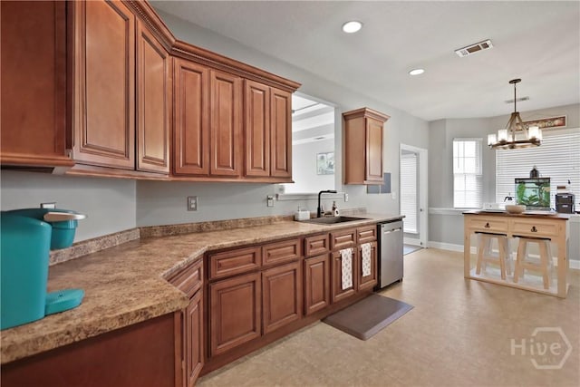 43 Gracie Ln NE, Ludowici, GA 31316 - kitchen with dishwasher, brown cabinets, pendant lighting, a chandelier, and light countertops
