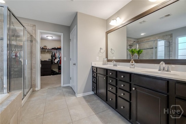55 Glen Way, Richmond Hill, GA 31324 - full bath with double vanity, a shower stall, a spacious closet, and tile patterned floors
