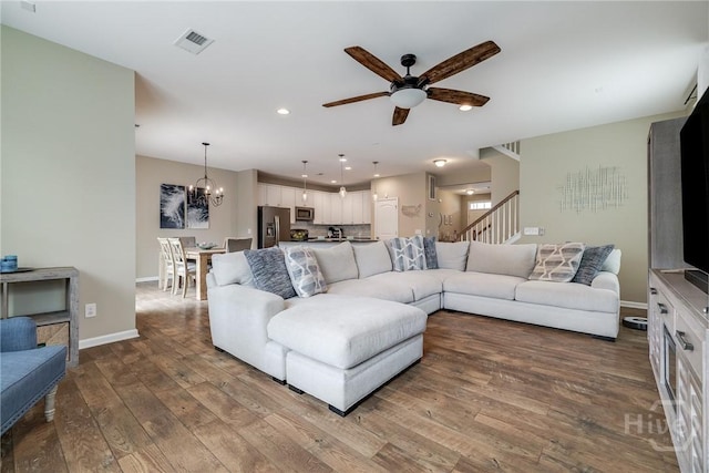 55 Glen Way, Richmond Hill, GA 31324 - living area with ceiling fan, a chandelier, wood-type flooring, recessed lighting, and stairway