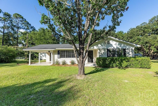 84 Poplar St, Guyton, GA 31312 - ranch-style house with a front lawn, a carport, and brick siding