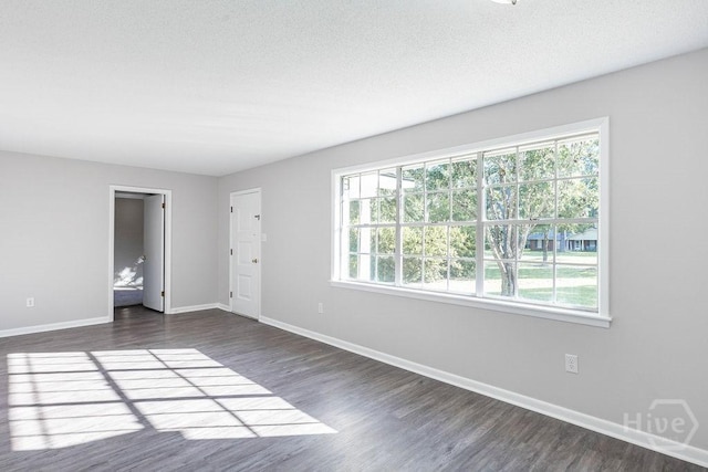 84 Poplar St, Guyton, GA 31312 - unfurnished room with dark wood-style flooring and a textured ceiling