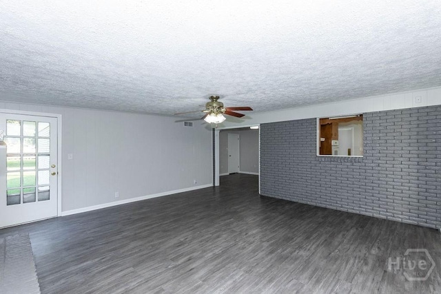 84 Poplar St, Guyton, GA 31312 - unfurnished living room with dark wood-style floors, a ceiling fan, brick wall, and a textured ceiling
