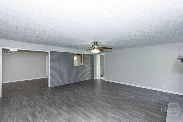 84 Poplar St, Guyton, GA 31312 - unfurnished living room with ceiling fan, dark wood-style floors, a textured ceiling, and wooden walls