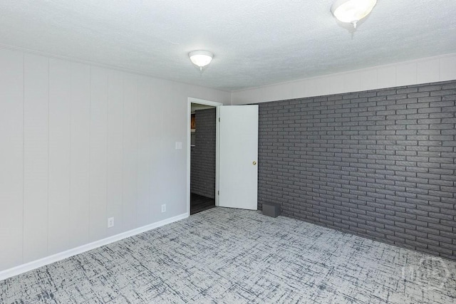 84 Poplar St, Guyton, GA 31312 - carpeted empty room featuring a textured ceiling and brick wall