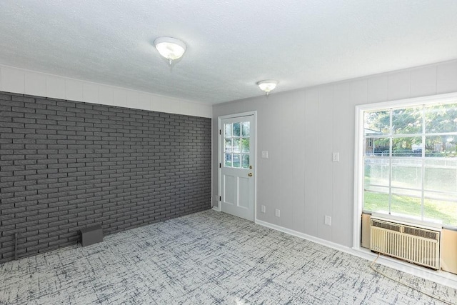 84 Poplar St, Guyton, GA 31312 - carpeted empty room featuring brick wall and a textured ceiling