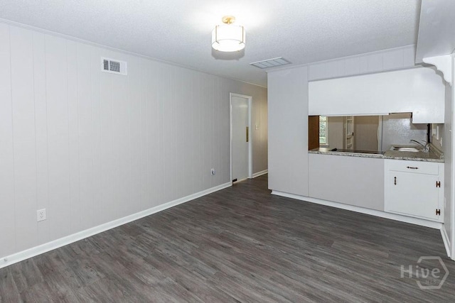 84 Poplar St, Guyton, GA 31312 - unfurnished living room with dark wood-style floors and a textured ceiling