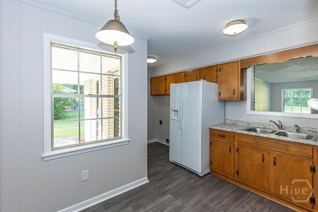 84 Poplar St, Guyton, GA 31312 - kitchen with white refrigerator with ice dispenser, brown cabinets, dark wood-type flooring, light countertops, and a textured ceiling