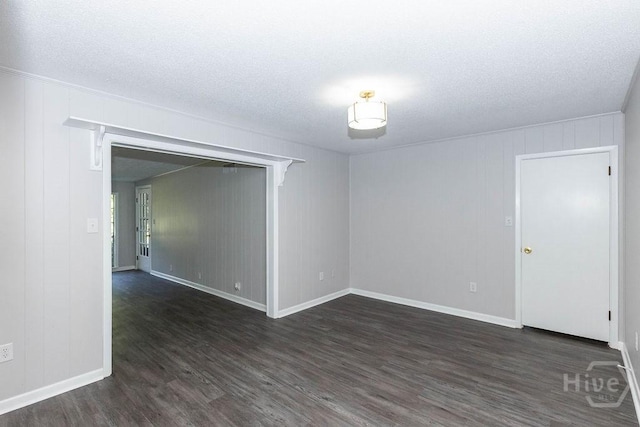 84 Poplar St, Guyton, GA 31312 - empty room with dark wood-style floors and a textured ceiling