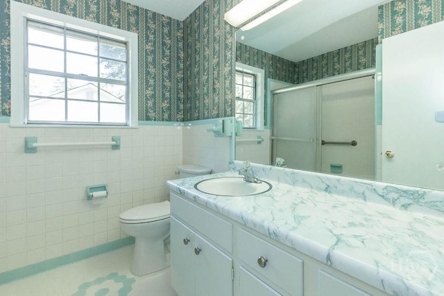 84 Poplar St, Guyton, GA 31312 - bathroom featuring wallpapered walls, vanity, a shower stall, wainscoting, and tile patterned floors