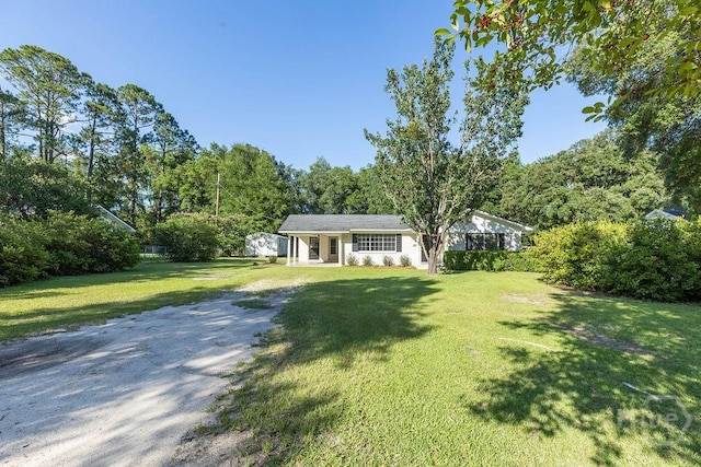 84 Poplar St, Guyton, GA 31312 - ranch-style house with a front yard and dirt driveway