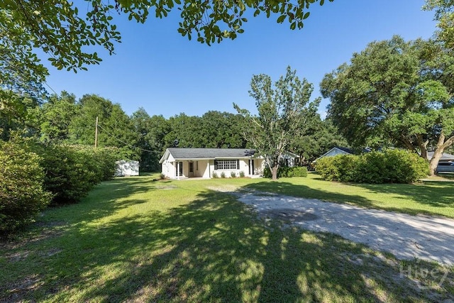 84 Poplar St, Guyton, GA 31312 - view of front facade with a front yard and driveway