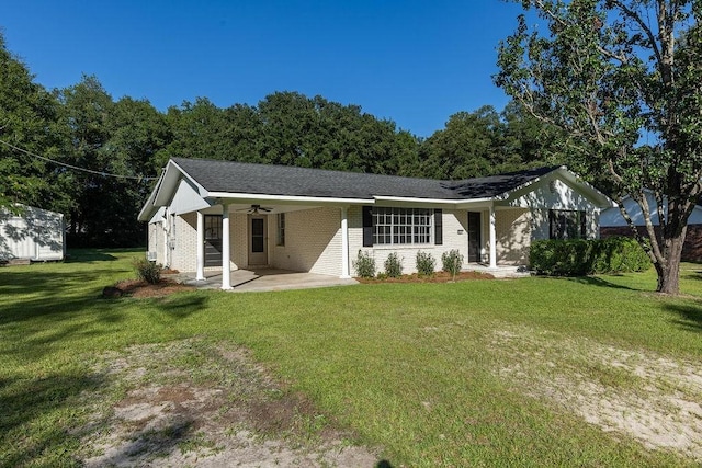 84 Poplar St, Guyton, GA 31312 - ranch-style home featuring an attached carport, a front yard, a ceiling fan, and brick siding
