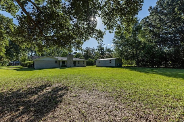84 Poplar St, Guyton, GA 31312 - view of green lawn featuring an outdoor structure