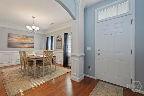 227 Chippingwood Cir, Pooler, GA 31322 - dining room featuring arched walkways, wood finished floors, ornate columns, crown molding, and wainscoting