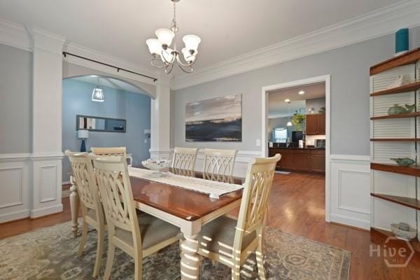 227 Chippingwood Cir, Pooler, GA 31322 - dining area with ornamental molding, a chandelier, arched walkways, wood finished floors, and wainscoting