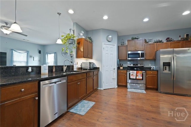 227 Chippingwood Cir, Pooler, GA 31322 - kitchen featuring appliances with stainless steel finishes, ceiling fan, wood finished floors, brown cabinets, and recessed lighting