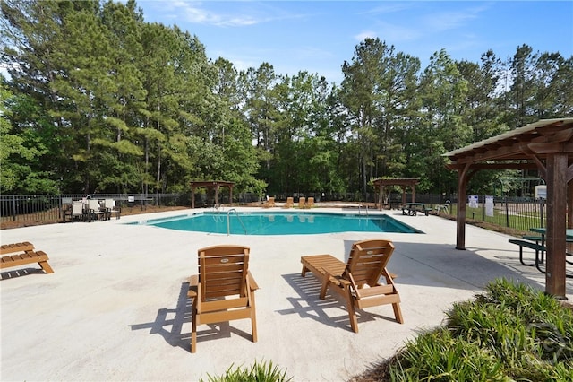 227 Chippingwood Cir, Pooler, GA 31322 - community pool with a pergola, a patio, and view of wooded area