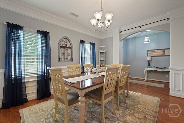 227 Chippingwood Cir, Pooler, GA 31322 - dining space with arched walkways, a chandelier, healthy amount of natural light, crown molding, and wood finished floors