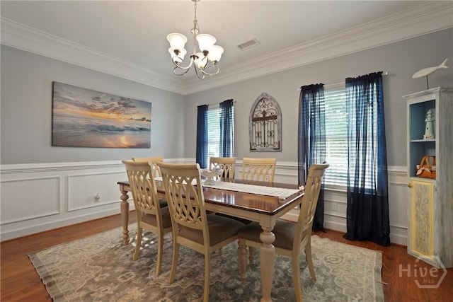 227 Chippingwood Cir, Pooler, GA 31322 - dining room with a chandelier, ornamental molding, healthy amount of natural light, wood finished floors, and a wainscoted wall