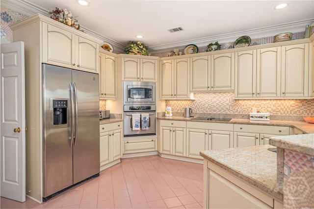 24 Islanders Retreat Retreat, Savannah, GA 31411 - kitchen with stainless steel appliances, cream cabinetry, light stone countertops, light tile patterned flooring, and backsplash