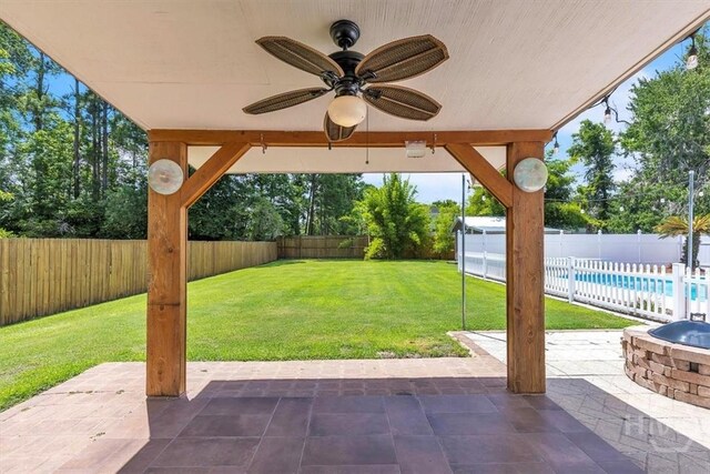 237 Robinson Loop, Richmond Hill, GA 31324 - fenced backyard with a patio area and ceiling fan