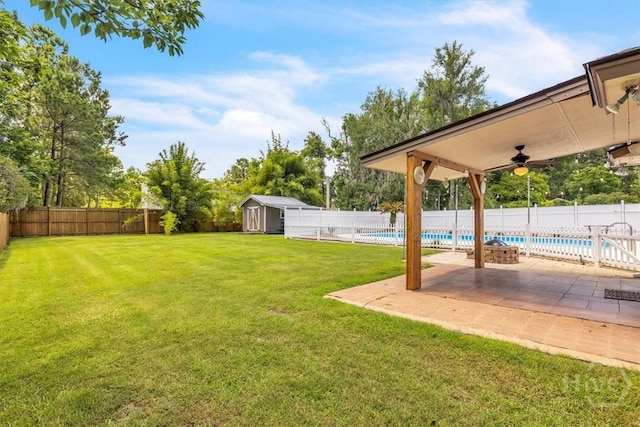 237 Robinson Loop, Richmond Hill, GA 31324 - fenced backyard with a shed, ceiling fan, and a patio area