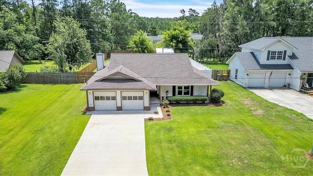 237 Robinson Loop, Richmond Hill, GA 31324 - view of front facade featuring driveway, an attached garage, and a chimney