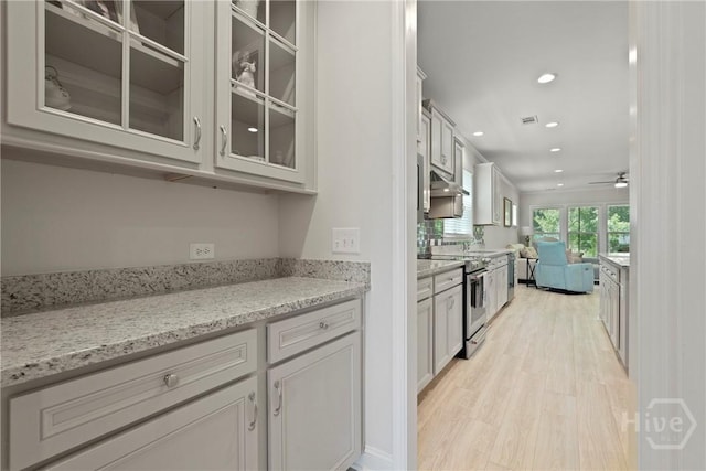 137 Harvest Hl, Pooler, GA 31322 - kitchen featuring electric range, open floor plan, glass insert cabinets, recessed lighting, and light wood-style flooring