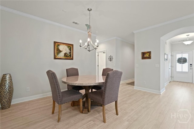 137 Harvest Hl, Pooler, GA 31322 - dining area featuring arched walkways, light wood-type flooring, a chandelier, and crown molding