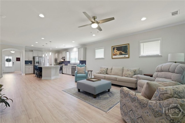 137 Harvest Hl, Pooler, GA 31322 - living room with crown molding, a ceiling fan, arched walkways, light wood-type flooring, and recessed lighting