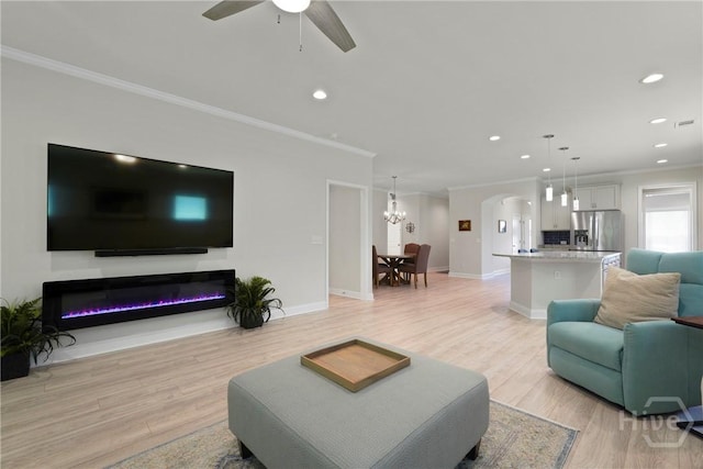 137 Harvest Hl, Pooler, GA 31322 - living area featuring ornamental molding, recessed lighting, light wood finished floors, arched walkways, and a ceiling fan