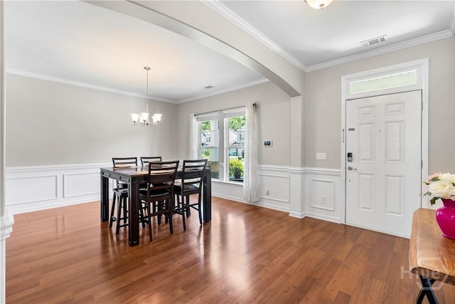 9 Melody Dr, Pooler, GA 31322 - dining room with arched walkways, wood finished floors, wainscoting, a chandelier, and ornamental molding