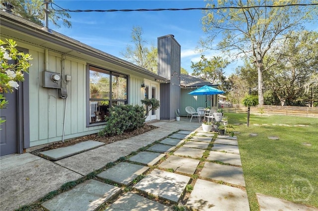 102 Phyllis Dr, Savannah, GA 31419 - rear view of property with a patio area, board and batten siding, and a chimney