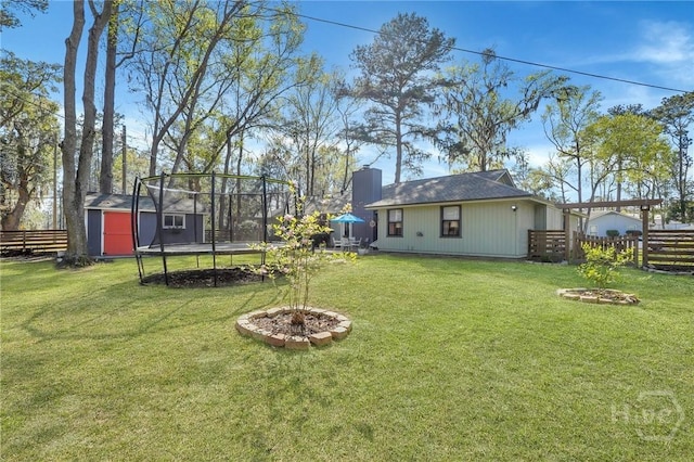102 Phyllis Dr, Savannah, GA 31419 - view of yard featuring a trampoline, a shed, and a fire pit