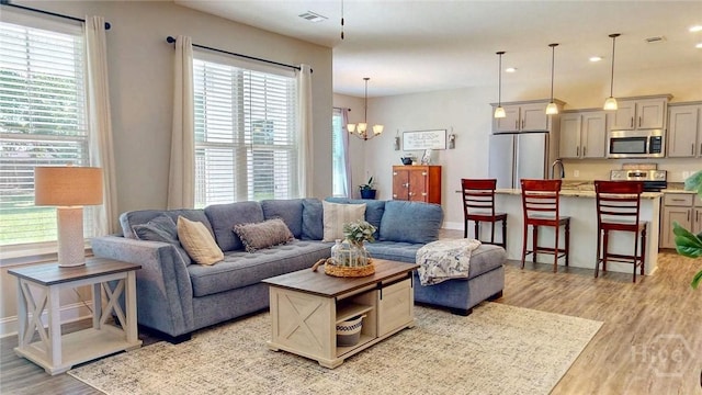 110 Tailwind Trl, Guyton, GA 31312 - living room featuring light wood-type flooring, healthy amount of natural light, a chandelier, and recessed lighting