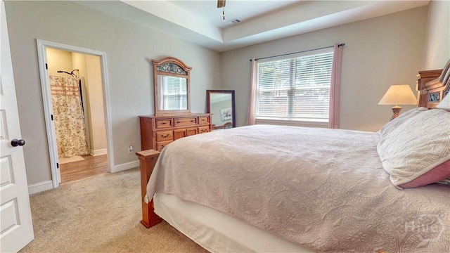 110 Tailwind Trl, Guyton, GA 31312 - bedroom featuring light colored carpet, a raised ceiling, ensuite bath, and a ceiling fan