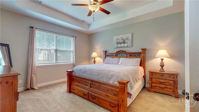 110 Tailwind Trl, Guyton, GA 31312 - bedroom with light carpet, a tray ceiling, and a ceiling fan