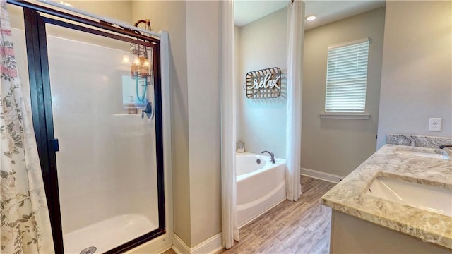 110 Tailwind Trl, Guyton, GA 31312 - bathroom with wood finished floors, a shower stall, a bath, and double vanity