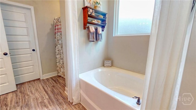 110 Tailwind Trl, Guyton, GA 31312 - bathroom with a garden tub and wood finished floors