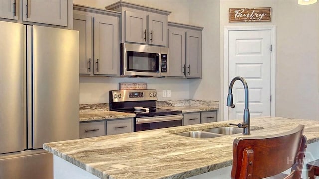 110 Tailwind Trl, Guyton, GA 31312 - kitchen featuring stainless steel appliances, gray cabinetry, and light stone counters