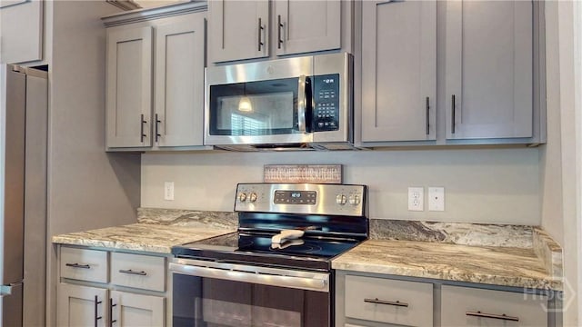 110 Tailwind Trl, Guyton, GA 31312 - kitchen featuring appliances with stainless steel finishes, gray cabinets, and light stone countertops